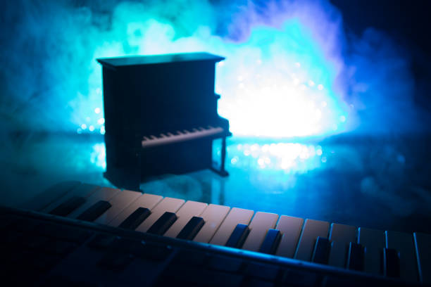 istock Creative concept. Artwork decoration with piano on dark toned foggy background with light. 1159197451