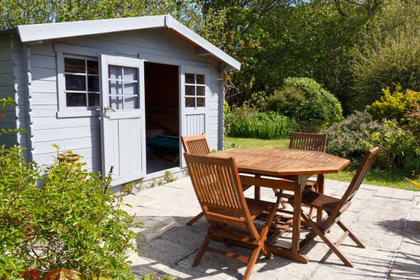 Shed with terrace and garden furniture Shed with terrace and wooden garden furniture during spring shed stock pictures, royalty-free photos & images