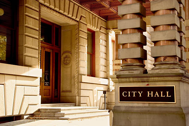 Outside of a city hall with a black plate on two columns stock photo