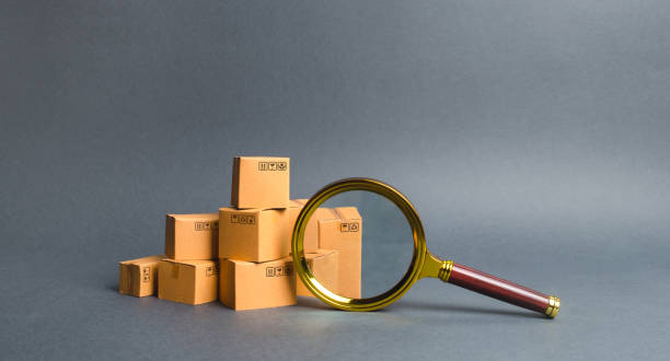 istock A pile of boxes and a magnifying glass. Concept search for goods and services. Tracking parcels. Quality control. Services for searching, comparing products from different trading companies. 1159201439
