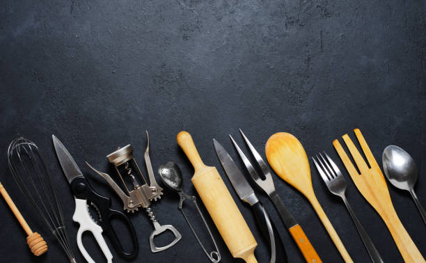 istock Wooden and metal kitchen utensils. Tools for cooking. Dark background. Flat lay. Copy space 1159201797