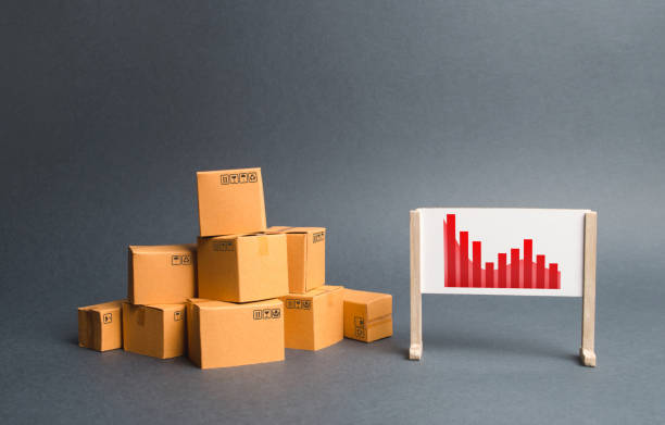 istock Stack of cardboard boxes and a stand with information chart. rate growth of production of goods and products, increasing economic indicators. exports or imports. Increasing consumer demand 1159201894