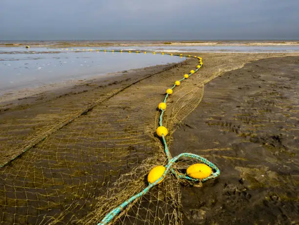 Photo of Tangled fishnet at the beach awaiting the next catch