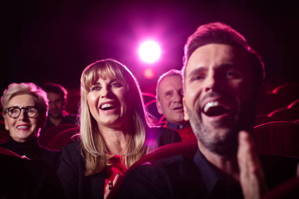 istock People watching comedy movie in theater 1159203817