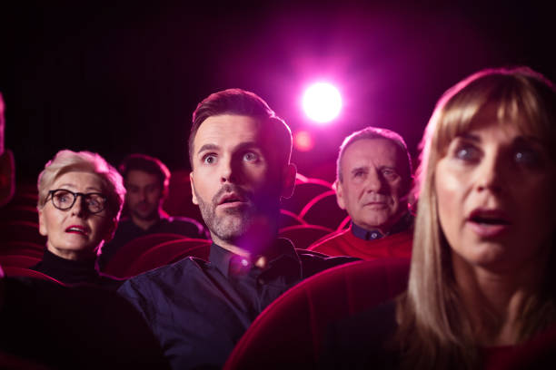 istock People watching a horror movie in a theater 1159203863
