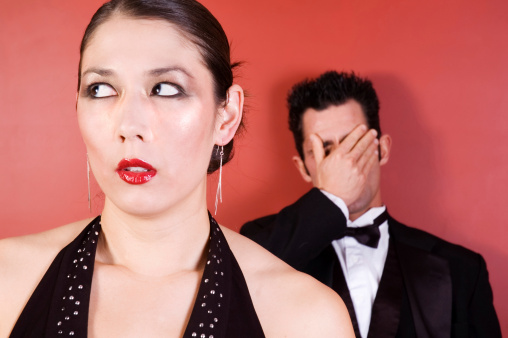 Asian female and Male, dressed up, displaying frustration in their faces