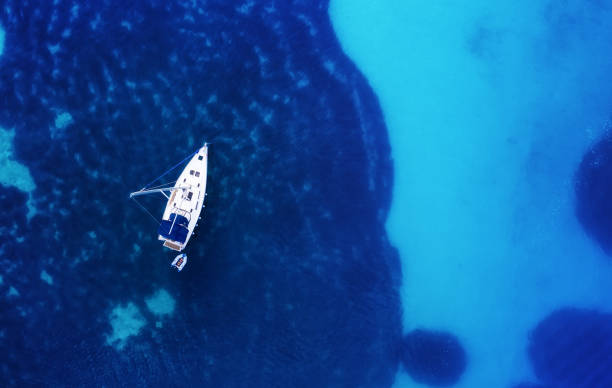 istock Yacht on the water surface from top view. Turquoise water background from top view. Summer seascape from air. Croatia. Travel - image 1159209595