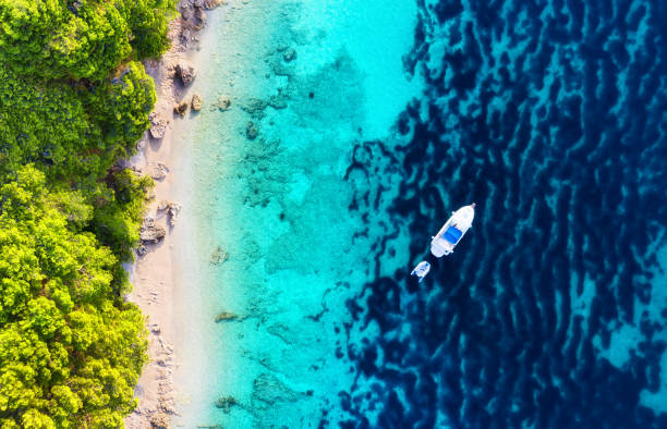 istock Yacht on the water surface from top view. Turquoise water background from top view. Summer seascape from air. Croatia. Travel - image 1159209596