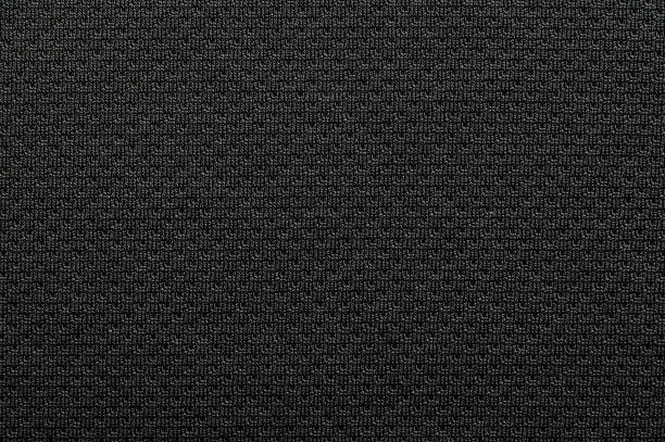 ブラックアスレチックシャツのクローズアップポリエステル生地テクスチャ - ナイロン ストックフォトと画像