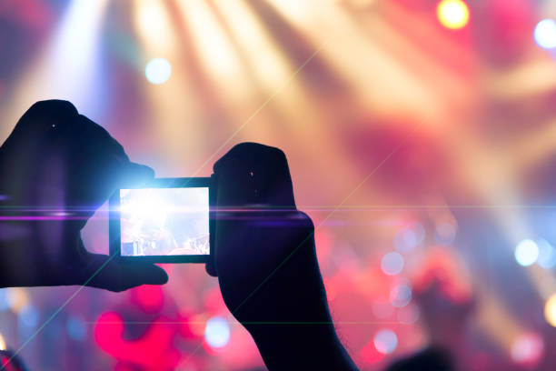 istock Filming concert on smart phone 1159211488