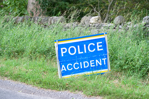 Police accident sign at road crash in rural countryside blind bend uk