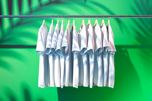 istock White t-shirts on green background with tropical plants shadows. 3d rendering. 1159216438