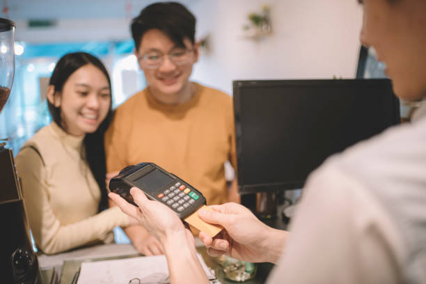 istock making contactless payment with smartphone at cafe 1159219315