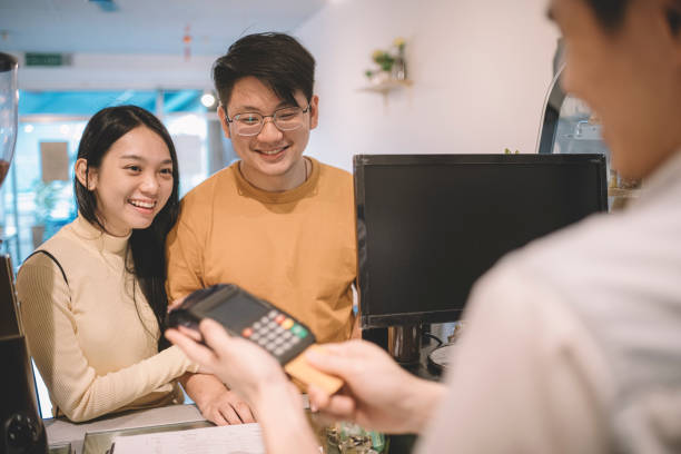 istock making contactless payment with smartphone at cafe 1159219404