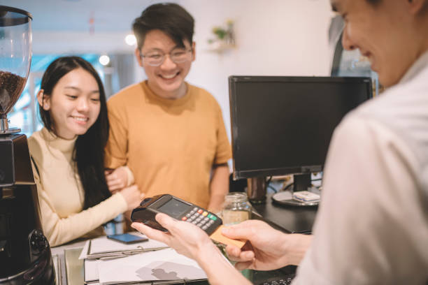 istock making contactless payment with smartphone at cafe 1159219446