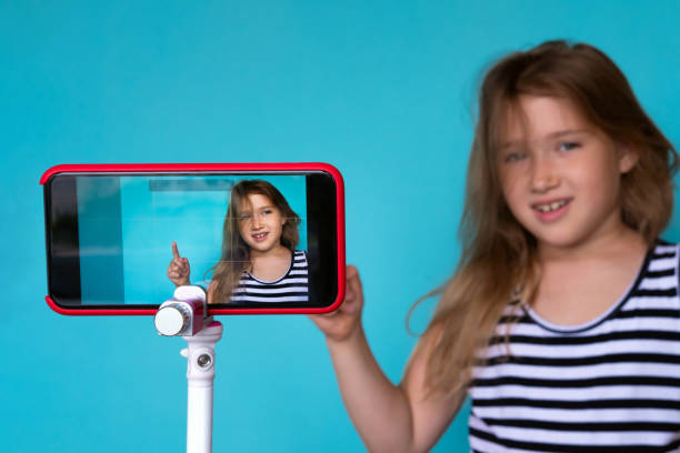 istock Girl posing in front of phone camera for selfie 1159219484
