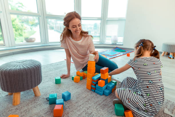istock Nice joyful woman playing with a girl 1159219816