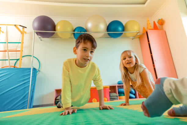 istock Pleasant cute boy and girl doing pushups 1159219822