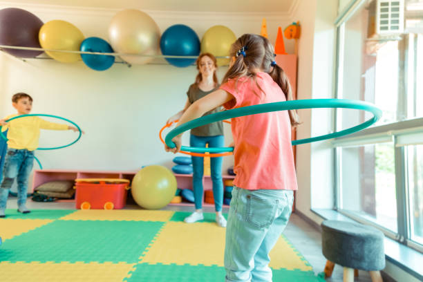 istock Joyful nice girl rotating a hula hoop 1159219825