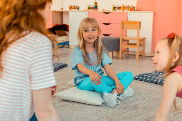 istock Nice blonde girl sitting on the pillow 1159219840