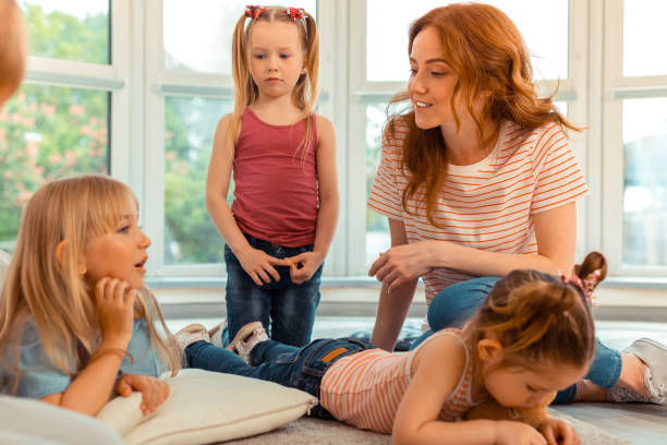 istock Positive young woman spending time with children 1159219854