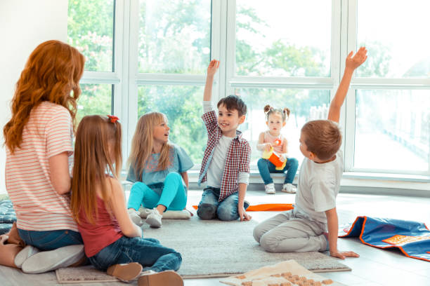 istock Happy smart boys raising their hands up 1159219858