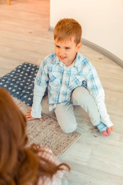 istock Positive nice boy smiling to his friends 1159219982