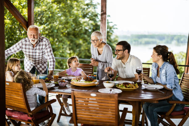 istock Happy multi-generation family talking while having lunch on a terrace. 1159221030