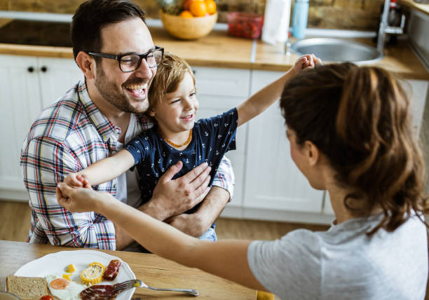 istock Young happy family having fun during breakfast in dining room. 1159221213
