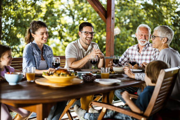 istock Happy multi-generation family having a talk during lunch on a terrace. 1159221956