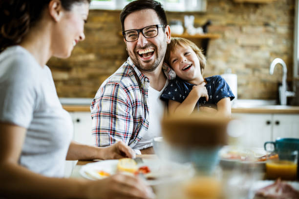 istock Cheerful family having fun while talking during breakfast at home. 1159222156