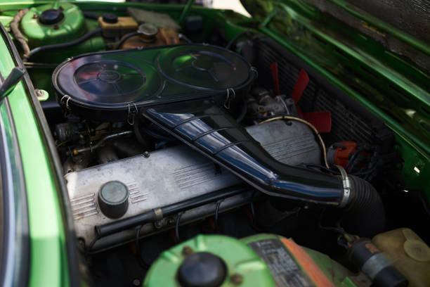 istock Engine of an old powerful car, green, with an open hood 1159223801