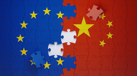 Jigsaw puzzle pieces textured with European Union and Chinese flags. Horizontal composition with copy space. Solution concept.