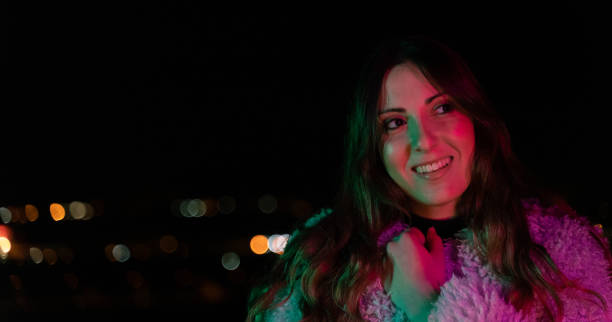 istock Trendy woman outdoors at night 1159225783