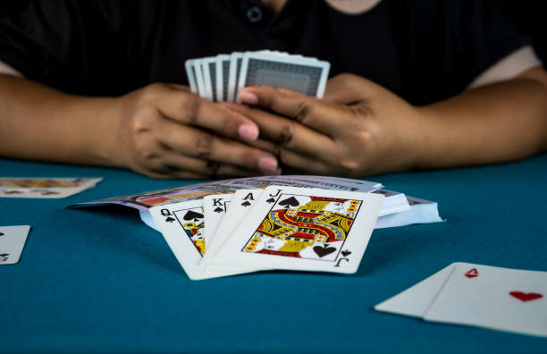 istock The gambler is playing cards in his hand. 1159225799