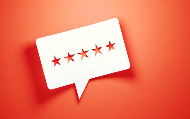 istock Feedback Concept - White Chat Bubble With Cut Out Star Shapes Over Pink Background 1159225804