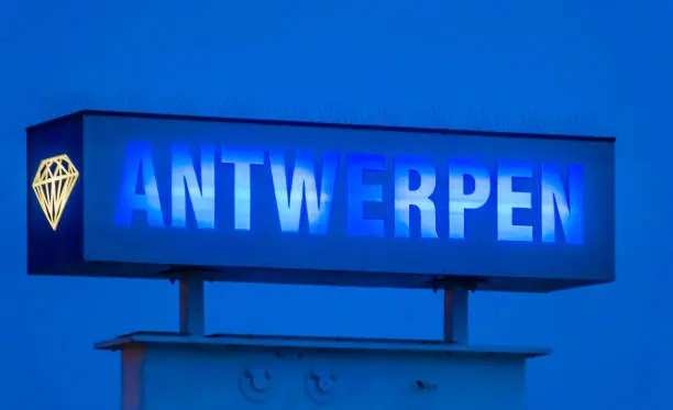 Photo of blue neon light board with the text antwerpen, Sign post by night in antwerp, Belgium