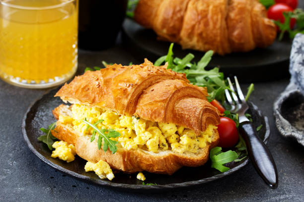 istock Breakfast of croissant with scrambled eggs and salad. 1159226432