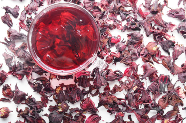 istock Top view of Hibiscus Tea cup with petals aside on white background 1159226475