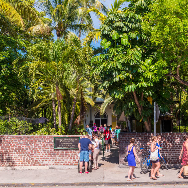 Entrance to Hemingway House in Key West Florida USA Key West, FL, USA - March 29, 2015: Tourists visit Hemingway House, the home of famous author Ernest Hemingway who lived here from 1931 to 1939. The house is now a museum. hemingway house stock pictures, royalty-free photos & images