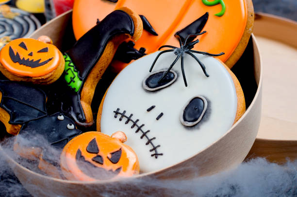 istock Halloween background with gingerbread, pumpkins and candles 1159229983