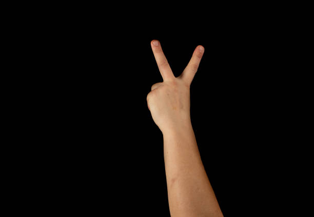 istock The hand of a young man on a black background 1159231898