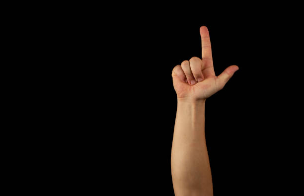 istock The hand of a young man on a black background 1159231902