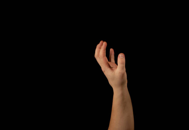 istock The hand of a young man on a black background 1159231924