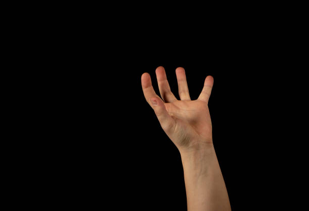 istock The hand of a young man on a black background 1159231928