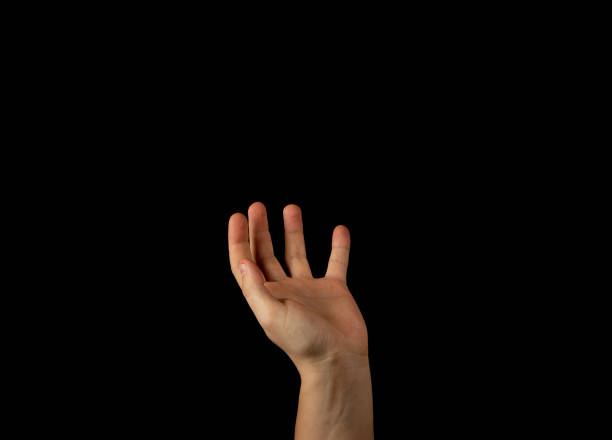 istock The hand of a young man on a black background 1159231931