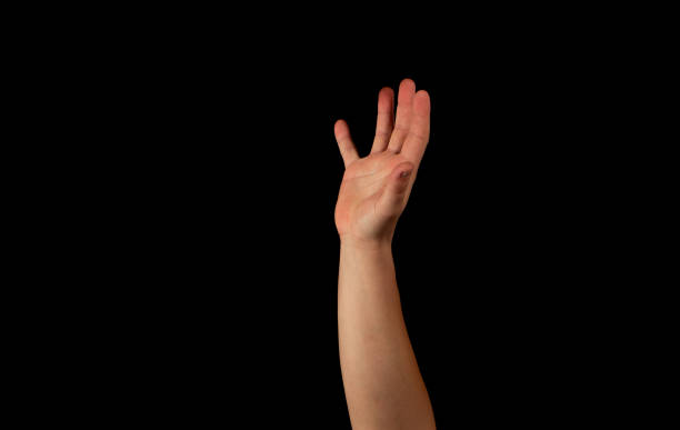 istock The hand of a young man on a black background 1159231974