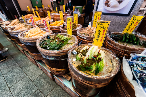 Kyoto, Japan - April 17, 2019: Containers of pickles pickled vegetables on sale display in Nishiki market street