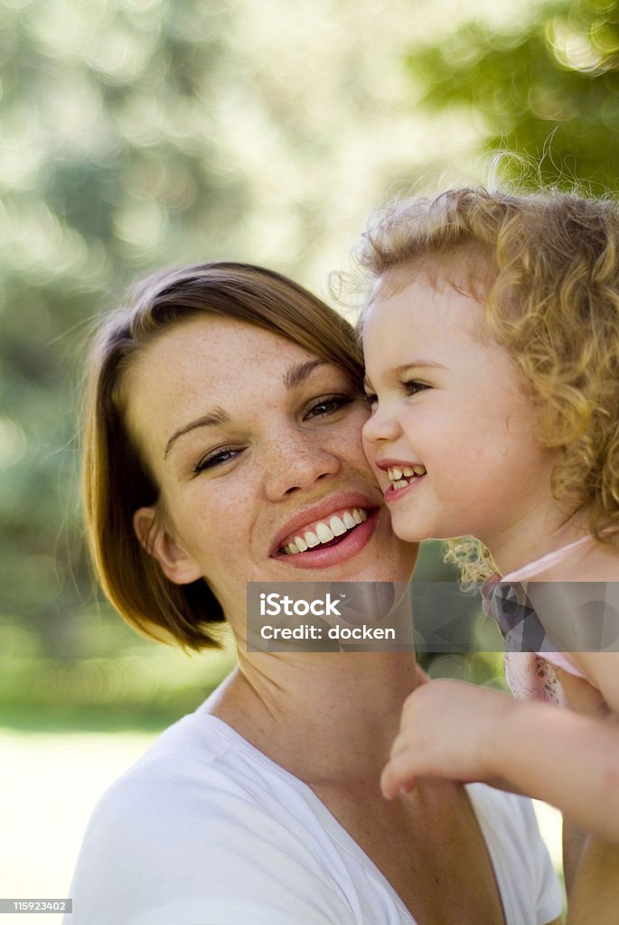 attractive mother and child mother holding baby girl outside 20-24 Years Stock Photo