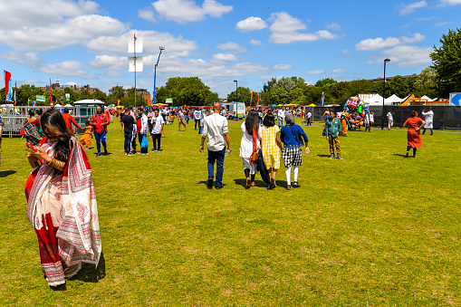 London, UK - June 30th, 2019 - People taking part in the Boishakhi Mela festival in Bethnal Green in London - The largest Bengali festival outside of Asia, celebrating the Bengali New Year with a parade, music and food.